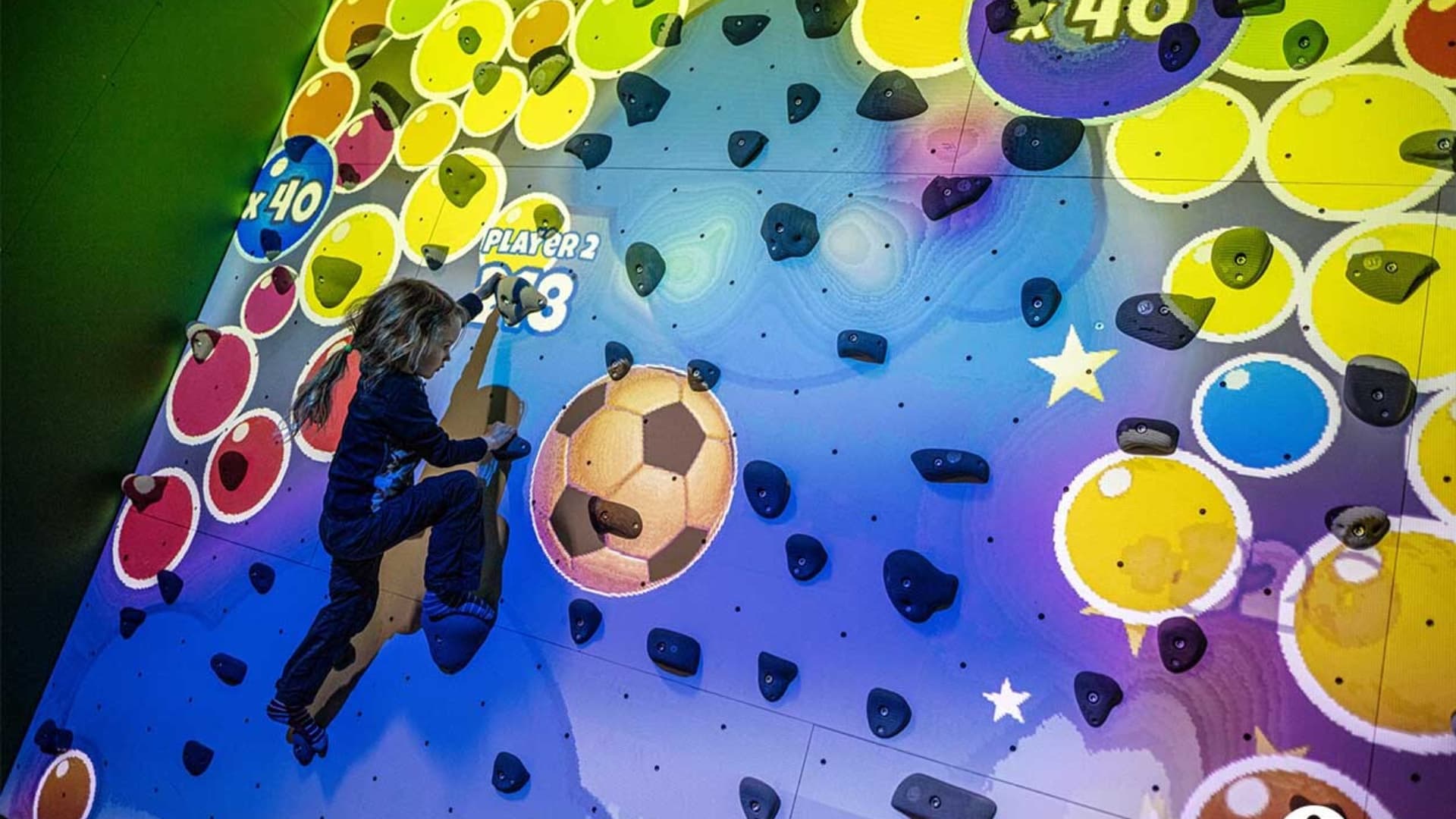 Person interacting with smart games in the Interactive Zone at The Hub Park, a leading indoor fun center in Karen.