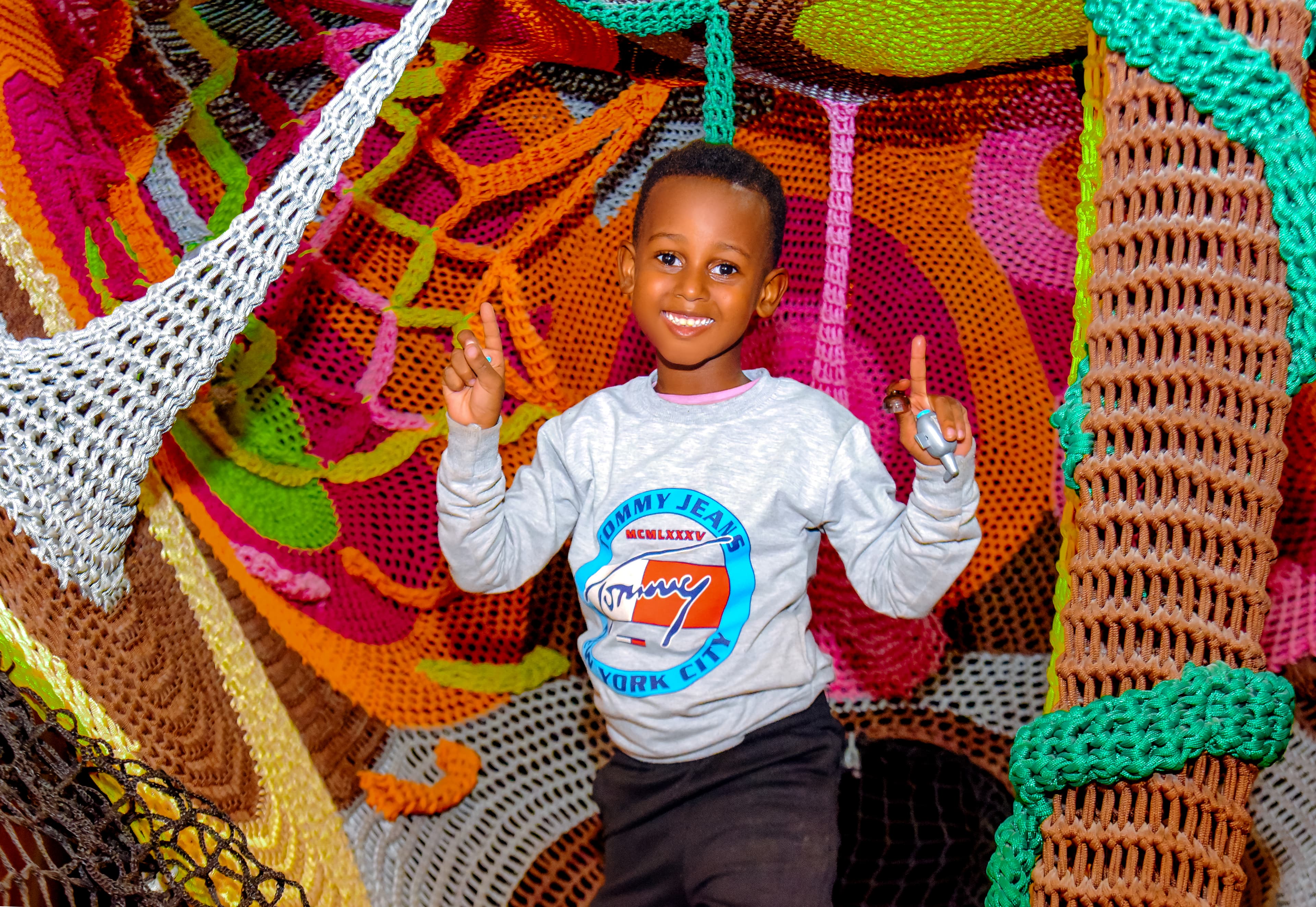 Child balancing in the net maze challenge at The Hub Park, a thrilling indoor fun zone and bounce place.